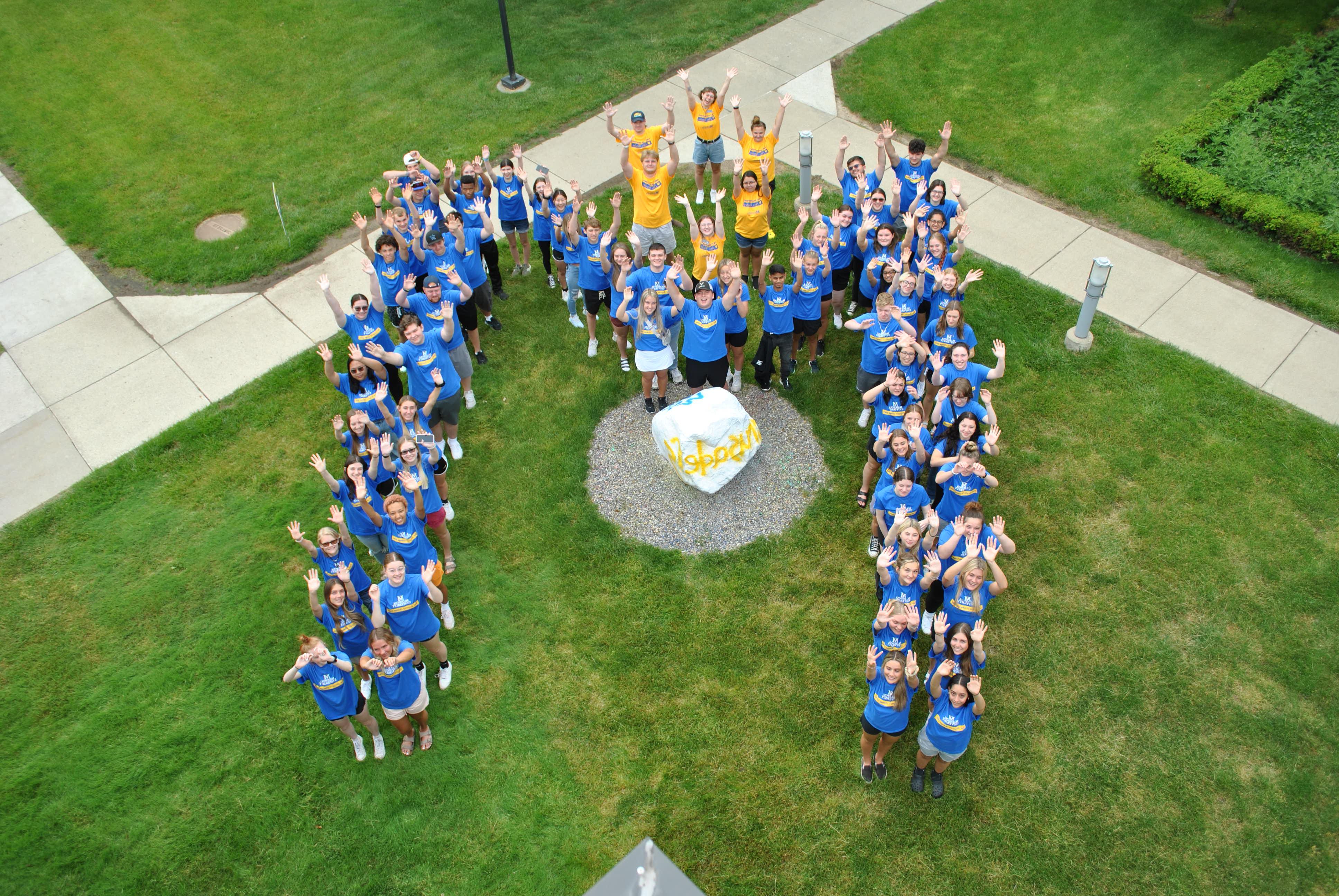 First-Year Experience creating the shape of the Madonna M around the School Rock, between the Franciscan Center and the Main Admin Building